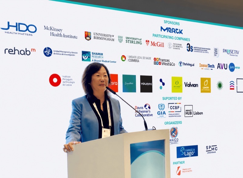 Frances West delivering a keynote from the podium